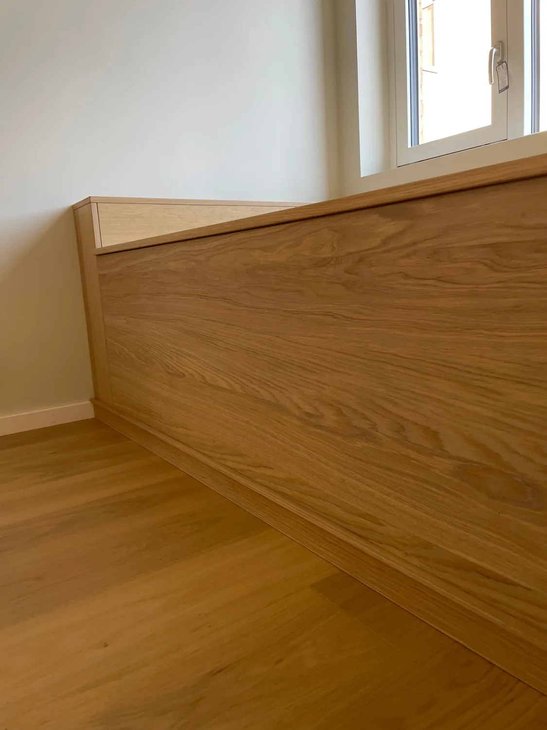 Fronten på brisken i eikefinert MDF med plankeskåret mønster, sett på skrå.