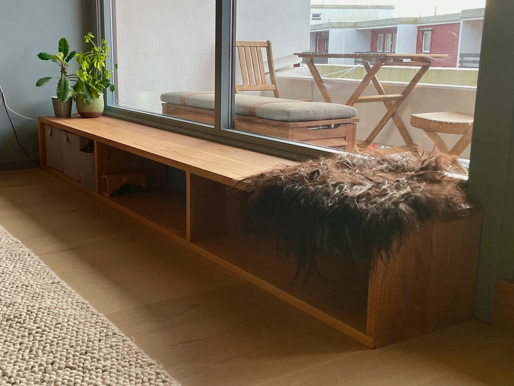 Sittebenk i eik sett fra siden, med åpne hyllerom under platen